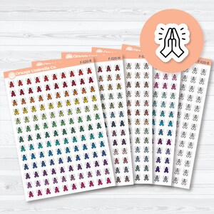 May include: A collection of sticker sheets featuring colorful praying hands and the text "Orange Umbrella Co." The stickers are in various colors, including red, orange, yellow, green, blue, and purple. A round sticker with praying hands is also visible.