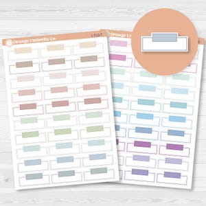 May include: Two sheets of planner stickers with rectangular designs in various pastel colors. Each sticker has a white rectangular box with a colored bar at the top. The brand name "Orange Umbrella Co." is visible.
