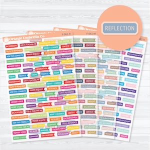 May include: A set of three sticker sheets from Orange Umbrella Co. featuring numerous small, colorful, rectangular flag-shaped labels with printed text including words like Reflection, Insight, Promise, Theme, and God Is Teaching Me.