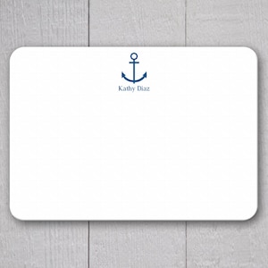 May include: White stationery card with a rounded corner design. A navy blue anchor graphic is centered at the top, with the name "Kathy Diaz" printed below it in navy blue. The card is set against a light wood grain background.