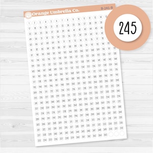 May include: A sheet of numbered stickers from 1 to 365, with a large sticker displaying the number 245. The stickers are arranged in rows and columns, with the brand name "Orange Umbrella Co." at the top.