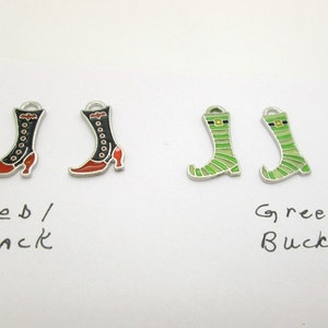 May include: Four metal boot charms, two black with red accents and two green with a gold buckle. The charms are labeled "Red/Black" and "Green Buckle".