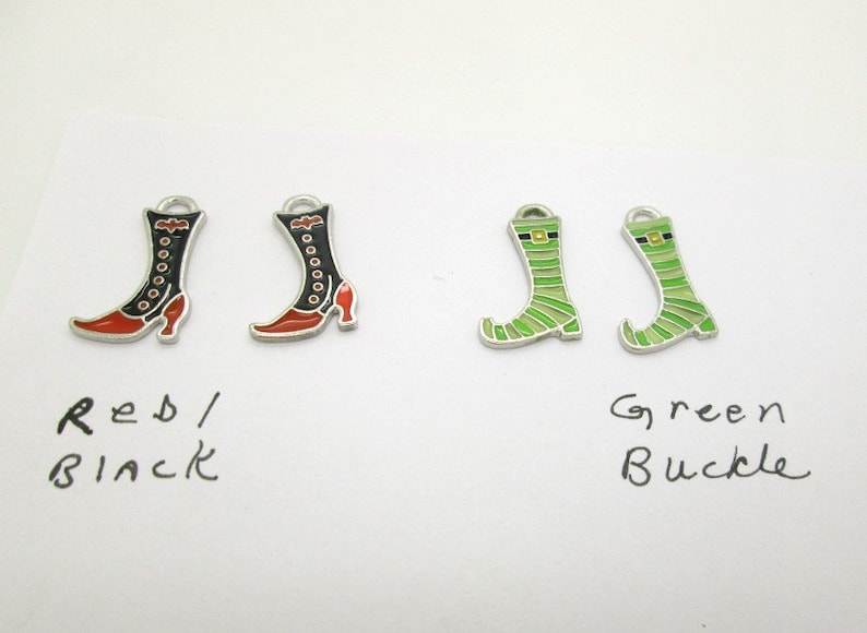 May include: Four metal boot charms, two black with red accents and two green with a gold buckle. The charms are labeled "Red/Black" and "Green Buckle".