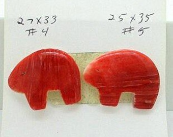 May include: Two red bear-shaped carvings, each with a rounded body and a cutout for legs. The carvings are displayed on a white background with handwritten measurements and numbers: 27x33 #4 and 25x35 #5.