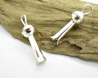 May include: Two silver metal bead caps with a loop at the top and a pointed end. The bead caps are designed to be used as end caps for necklaces or bracelets.
