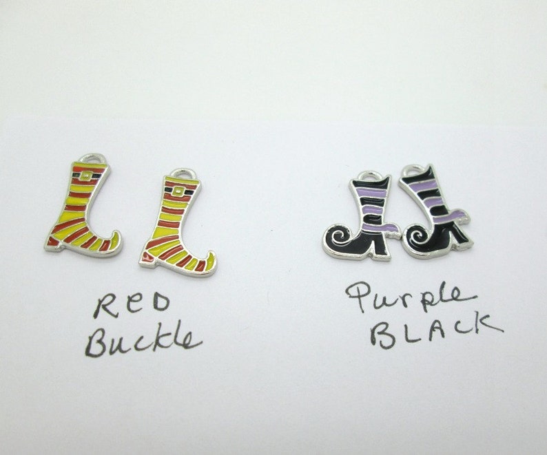 May include: Two pairs of witch boot charms. One pair is yellow and red with a black buckle. The other pair is black with purple stripes. The text "Red Buckle" and "Purple Black" is written below each pair.