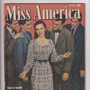 May include: A vintage magazine cover featuring a group of young people, including a woman in a patterned dress, with the title "Miss America" and the text "How to handle FIRST CRUSHES by Shirley Temple".