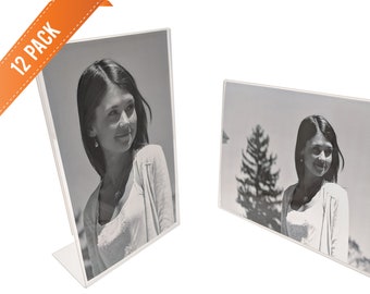 May include: A 12-pack of clear acrylic photo frames. Each frame is designed to hold a 4x6 inch photo and features a slanted stand for tabletop display.
