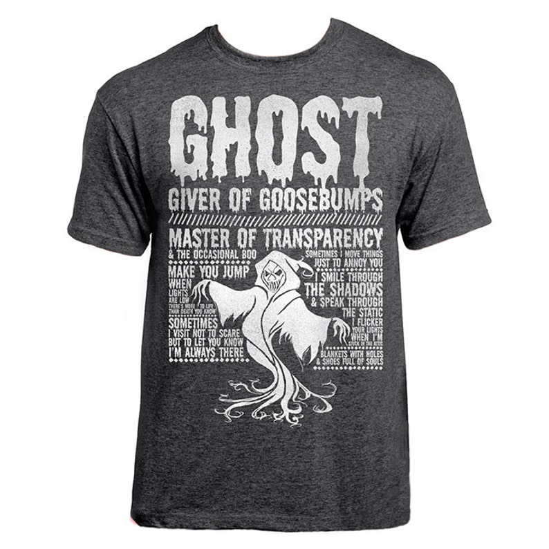 May include: A dark gray t-shirt with a white graphic print of a ghost. The text reads "Ghost, Giver of Goosebumps, Master of Transparency".
