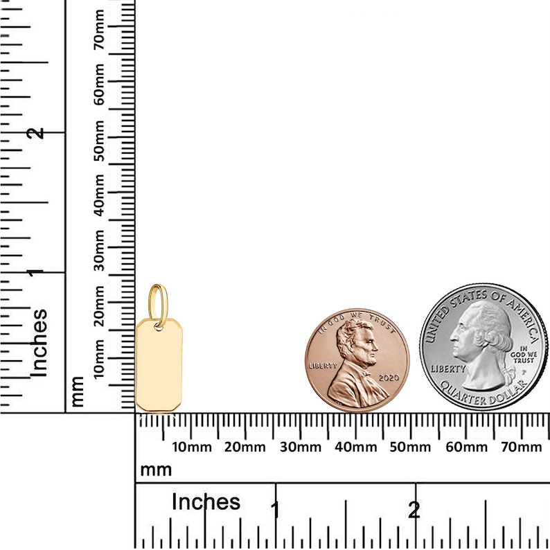 May include: A gold-colored metal pendant in the shape of a rectangular tag. The pendant is about 1 inch long and 1/2 inch wide. The pendant is shown next to a US quarter and a US penny for size comparison.