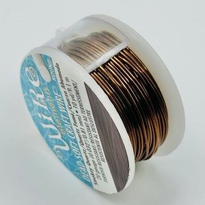 May include: A spool of 20 gauge, 10 yard, dead-soft craft wire in a smoky quartz colour. The wire is tarnish-resistant and is labelled "Wike elements".