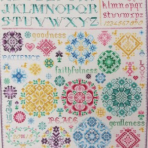 May include: Cross stitch pattern with a white background and colourful floral designs. The pattern includes the alphabet, numbers, and words like "goodness", "faithfulness", "peace", "gentleness", and "kindness".