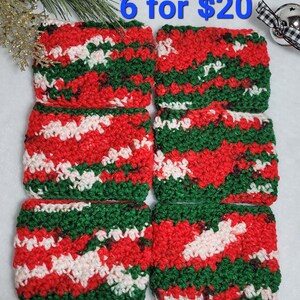May include: Six handmade crochet coasters in red, green, and white. The coasters have a textured, woven appearance with a festive color scheme. The text "6 for $20" is visible in the image.
