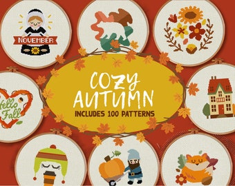 May include: A set of 100 cross stitch patterns with a cozy autumn theme. The patterns include images of a house, a gnome, a pumpkin, a fox, a girl in a pilgrim outfit, a wreath with flowers, a heart with the words "Hello Fall", and a bear in the woods. The patterns are perfect for fall decorating or as gifts.