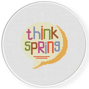 May include: A white circle with a yellow speech bubble that says "think spring" in colorful letters. The letters are in different colors, including red, orange, yellow, green, blue, and purple.