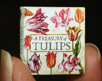 May include: A small book with a white cover and colorful illustrations of tulips. The title of the book is "A Treasury of Tulips".