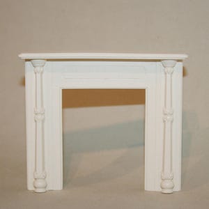 May include: White painted wooden fireplace mantel with ornate detailing. The mantel has a rectangular opening and a flat top.