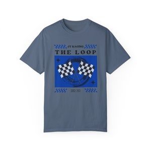 May include: A blue t-shirt with a graphic of two checkered flags crossed over a blue circle with a white brushstroke. The text "JT Racing" and "The Loop" are above the graphic, and "Since 2013" is below the graphic.
