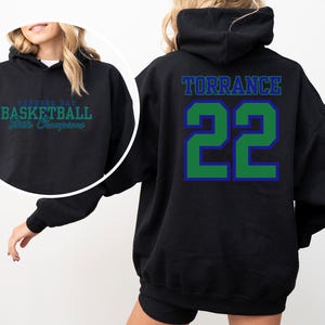 May include: Black hoodie with the word "TORRANCE" and the number "22" in green and blue lettering on the back. The front of the hoodie has the text "TORRANCE BAY BASKETBALL State Champions" in green and blue.