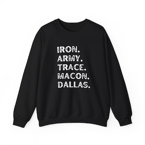 May include: Black crew neck sweatshirt with white text reading "IRON. ARMY. TRACE. MACON. DALLAS." The sweatshirt has long sleeves and a round neckline. The text is vertically aligned and centered on the chest.