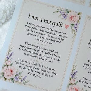 May include: A rectangular paper tag featuring the text I am a rag quilt, with care instructions for washing and drying. The design is decorated with watercolor illustrations of pink roses and purple lavender flowers in the corners.