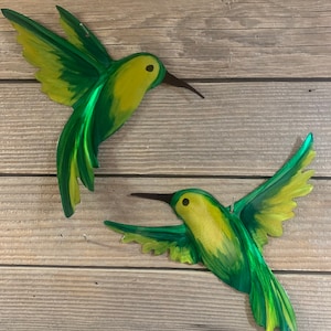 Lime, yellow and green hovering and inflight metal hummingbird metal art.