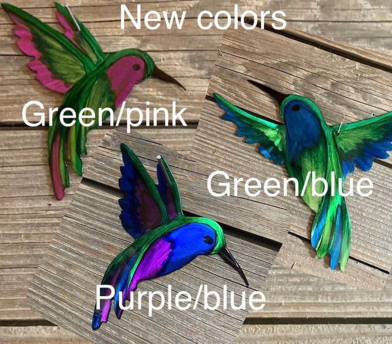 Hovering and inflight metal hummingbirds. Wall or yard art. Hand painted colors in green and pink, green and blue and purple and blue.