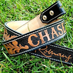 May include: Black leather belt with brown stitching and the names "CHASE" and "Romany" embossed in brown lettering.