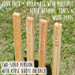 May include: Four wooden stakes with engraved Bible verses: Psalm 91:10, Isaiah 41:10, Numbers 6:24-26, and Joshua 1:9. The stakes are light brown and stand upright in grass. Text at the top says "FOUR PACK" and "AVAILABLE WITH MULTIPLE VERSE OPTIONS, FONTS & WOOD TYPES."