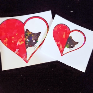 Red Heart avec autocollant Peeking Black Cat Stratifié holographique sur vinyle imperméable à l’eau et résistant à la décoloration pour ordinateur portable ou téléphone 2 « et 3 » tailles