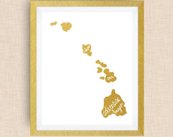 May include: Gold foil print of the Hawaiian islands with the text "where our adventure began" on the largest island.