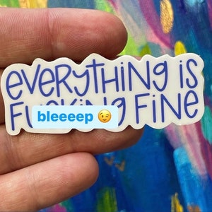 May include: White sticker with blue text that reads "Everything is bleeping fine" with a blue smiley face.