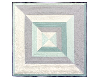May include: A square quilt with a geometric pattern of stripes and squares in shades of blue, green, and white.