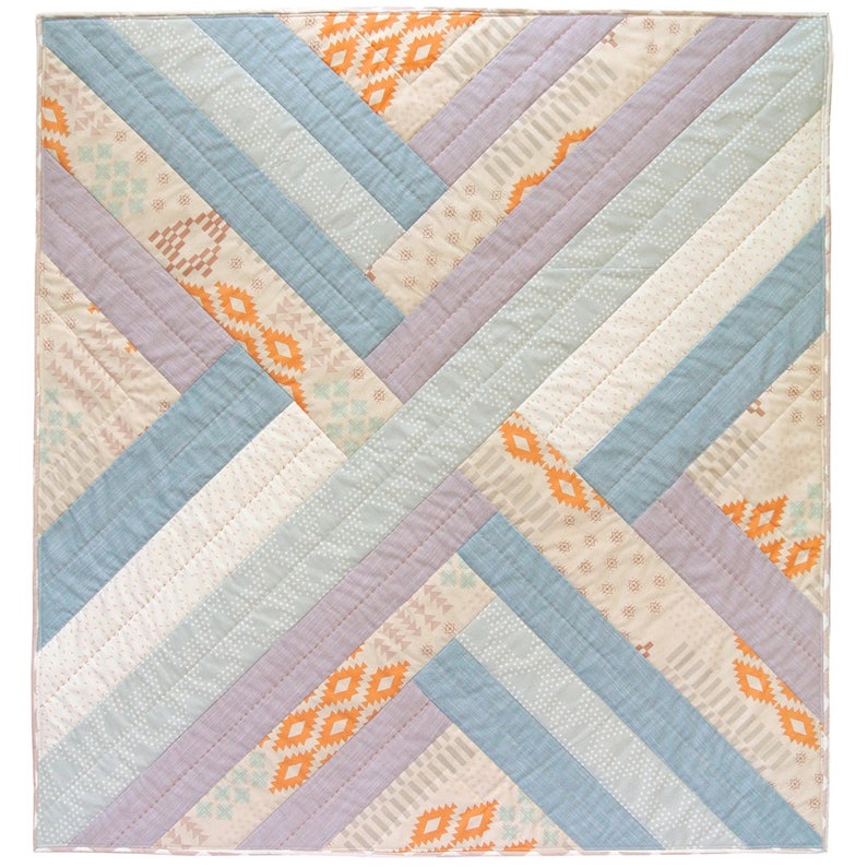 May include: A quilt with a geometric pattern in shades of blue, purple, and orange. The quilt is made of fabric with different patterns, including stripes, dots, and geometric shapes.
