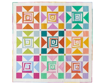 May include: A quilt with a geometric pattern of squares and triangles in various colors, including pink, orange, green, blue, and yellow.