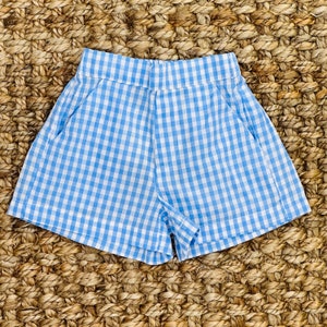 May include: Blue and white gingham shorts with a relaxed fit and side pockets.