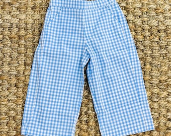 May include: Blue and white gingham check pants with a wide leg.