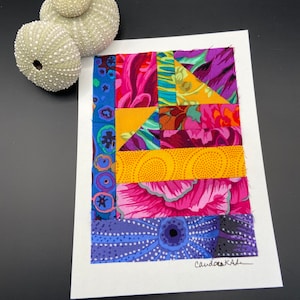 May include: A colorful patchwork quilt block with a variety of floral and geometric patterns in shades of pink, purple, yellow, and blue. The block is signed "Candace Kale" in the bottom right corner.
