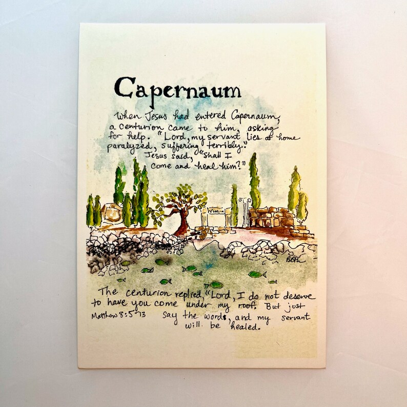 May include: Watercolor illustration of Capernaum with text from Matthew 8:5-13. The artwork depicts a landscape with trees, buildings, and water, with the title "Capernaum" at the top. The text is handwritten.