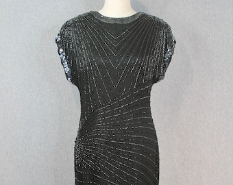 May include: A black sequined maxi dress with a geometric pattern. The dress has a scoop neckline and short sleeves.