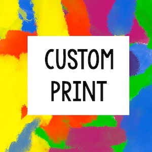 May include: Abstract art print with a vibrant mix of colors including yellow, orange, red, pink, green, and blue. A white rectangle in the center displays the words "CUSTOM PRINT" in black, bold letters. The artwork has a painted, textured appearance.