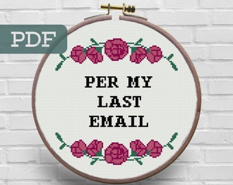 May include: A white embroidery hoop with a brown wooden frame. The hoop contains a cross-stitch design with pink roses and green leaves. The text "PER MY LAST EMAIL" is stitched in black thread.