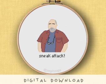 May include: Cross-stitch embroidery in a wooden hoop. The design features a pixelated illustration of a man in a red shirt and blue shirt, with the text "sneak attack!" below. The words "DIGITAL DOWNLOAD" are at the bottom.