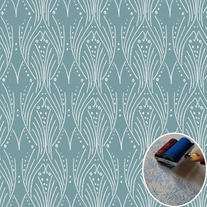 May include: A blue and white patterned stencil with a roller brush and a sample of the pattern printed on a white surface. The stencil is designed with a repeating pattern of stylized leaves and dots.