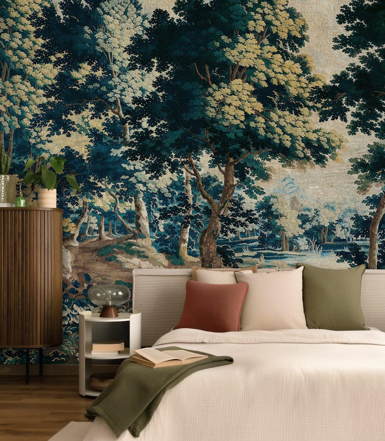 Vintage medieval wall tapestry mural in rich deep blue, green, and warm earthy tones, featuring an antique forest scene with mature trees, dense foliage and a tranquil stream, styled in a restful bedroom with a soft upholstered bed, layered neutral bedding, warm wood furnishings, and muted green accents. The historic woodland creates a restful sanctuary with timeless European character, perfect for Airbnb hosts or renovators seeking a distinctive Arts and Crafts bedroom design.