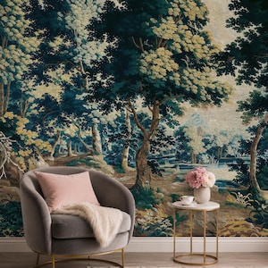 Verdure forest tapestry wall mural in rich deep blue, muted green, and warm earthy tones, featuring mature trees, lush woodland foliage, delicate wildflowers, and a tranquil pond, styled in an elegant sitting area with a taupe accent chair, soft blush cushion, brass side table, and fresh flowers, creating a serene yet sophisticated statement wall for those embracing classic European interiors, heritage-inspired decor, and timeless understated luxury.
