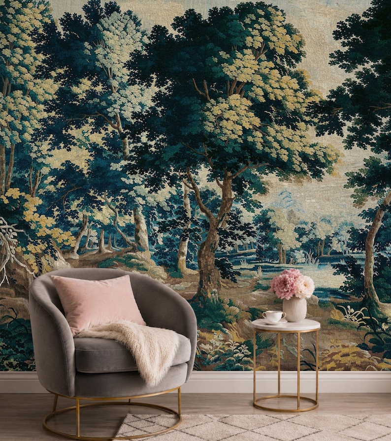 Verdure forest tapestry wall mural in rich deep blue, muted green, and warm earthy tones, featuring mature trees, lush woodland foliage, delicate wildflowers, and a tranquil pond, styled in an elegant sitting area with a taupe accent chair, soft blush cushion, brass side table, and fresh flowers, creating a serene yet sophisticated statement wall for those embracing classic European interiors, heritage-inspired decor, and timeless understated luxury.