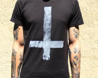 May include: A black t-shirt with a white upside-down cross printed on the front.