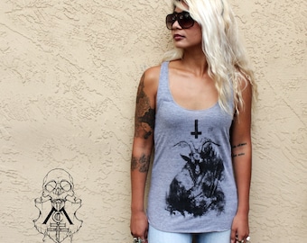 May include: A gray tank top with a black and white graphic print of a goat with an upside-down cross. The graphic is a stylized illustration of a goat with horns and a cross above its head.