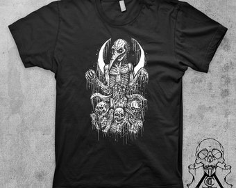 May include: Black t-shirt with a white graphic print of a skeletal figure with a bird beak, surrounded by skulls and dripping with liquid. The figure is standing in a crescent moon shape.